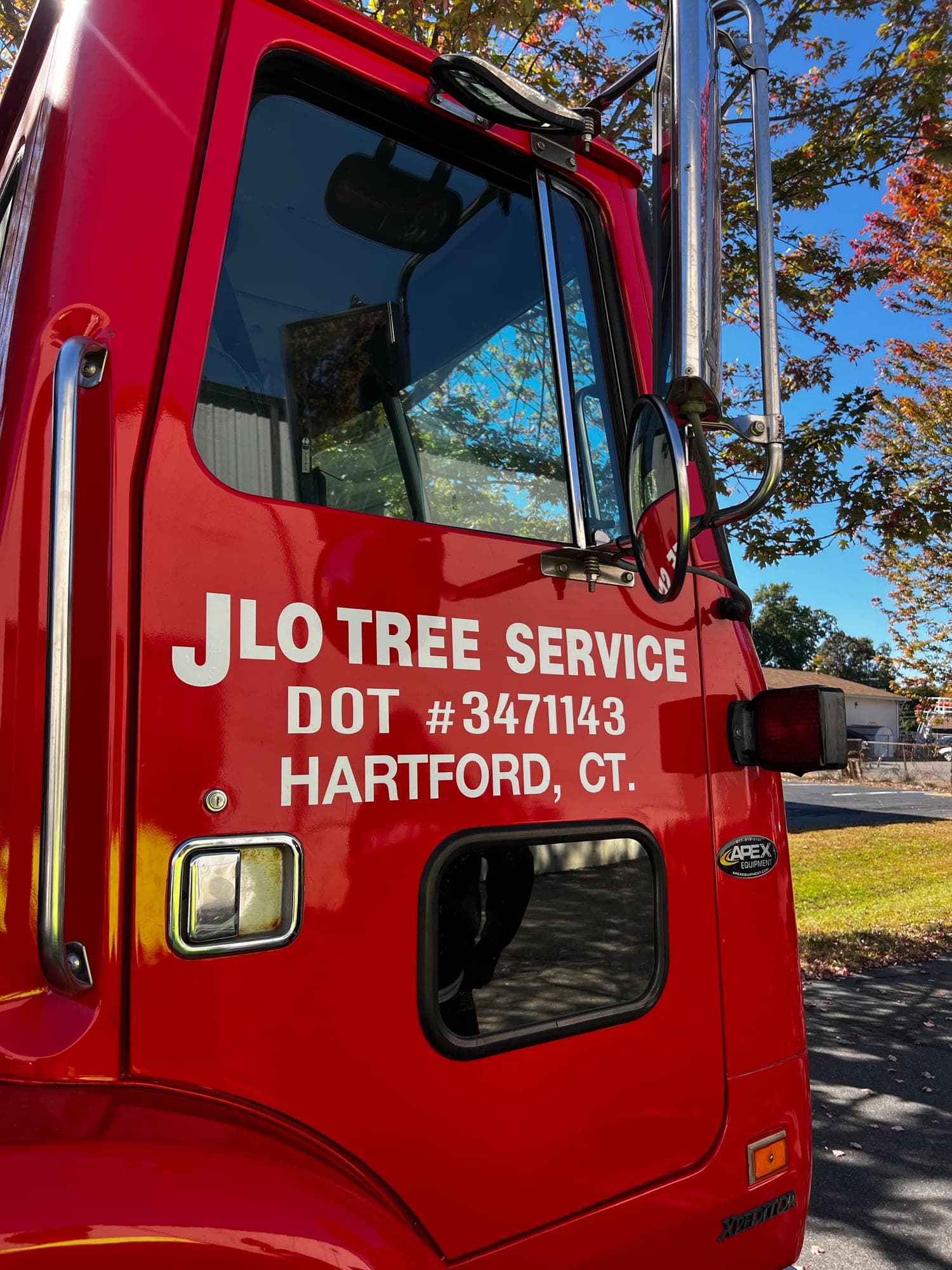 Door of a red JLO Tree Service truck marked Hartford, CT