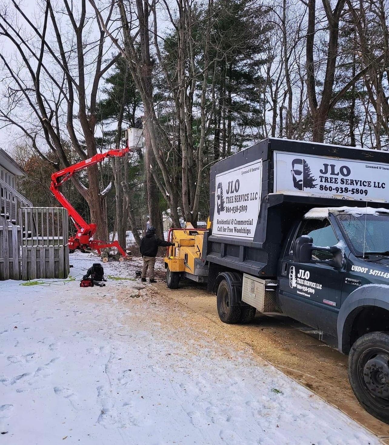 JLO chip truck and spider lift at a snowy job site