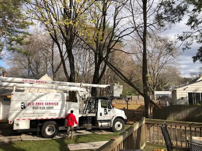 JLO bucket truck set up in a backyard beside a deck