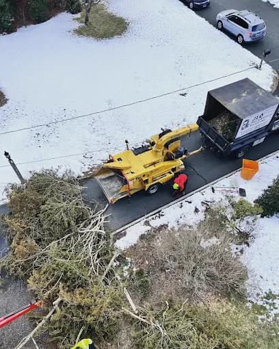 View from above of a chipper feeding a chip truck in the snow
