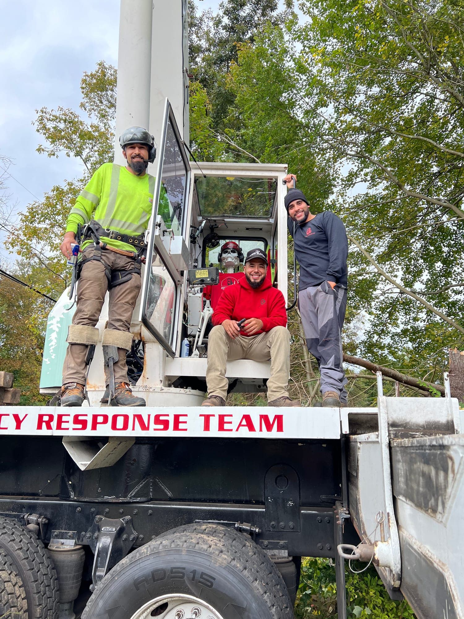 JLO Tree Service crew posing in and around a bucket truck