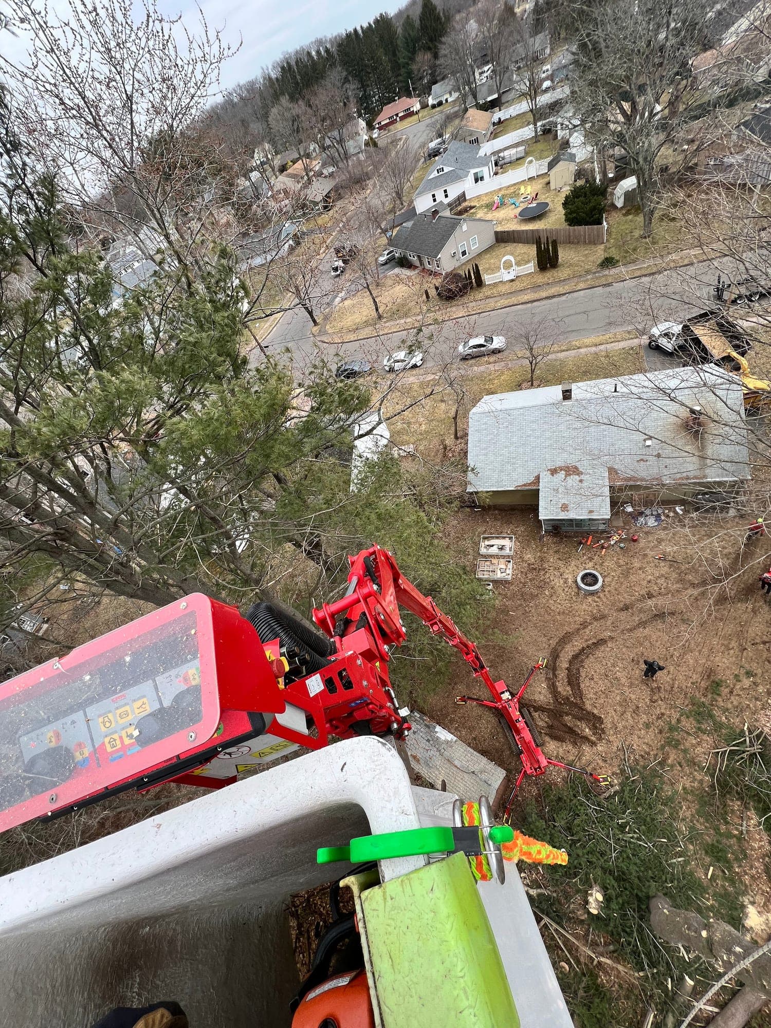 View from a JLO lift bucket high above a neighborhood tree job