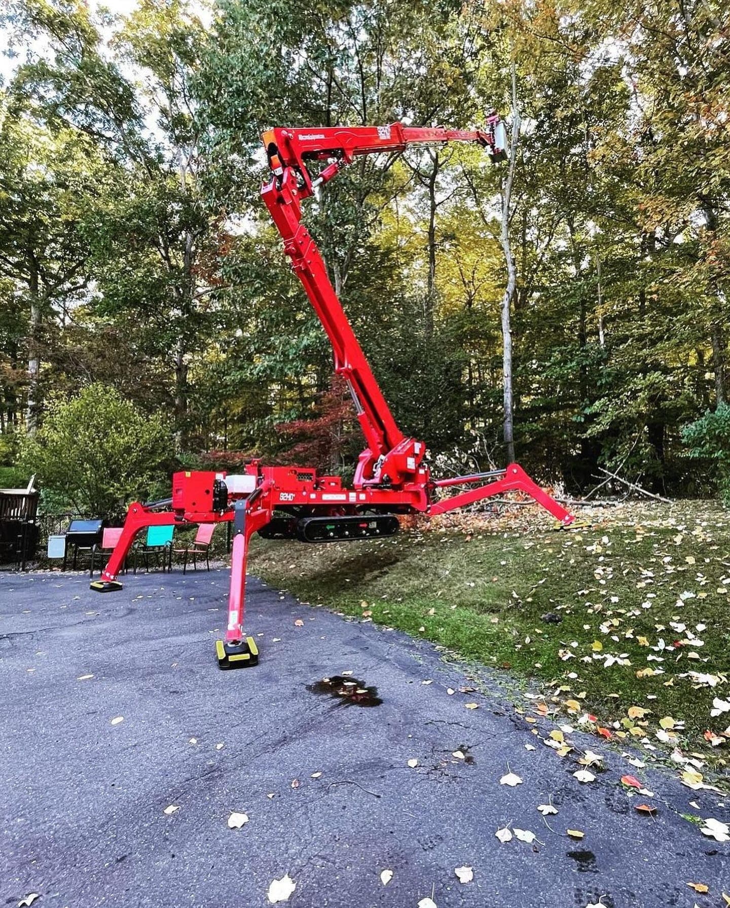 JLO spider lift extended over a driveway in autumn