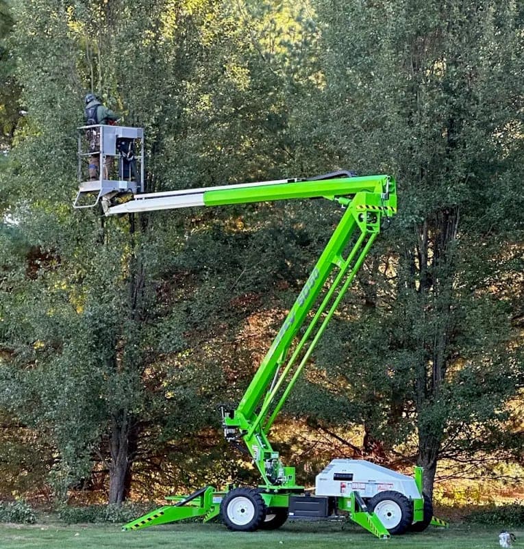 Aerial lift used for tree trimming and pruning by JLO Tree Service